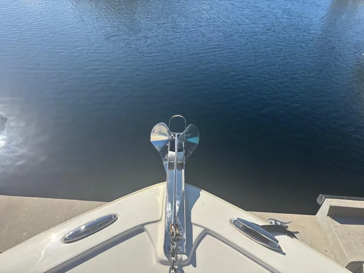  Yacht Photos Pics Bow of a 2013 Scout 282 XSF boat on calm water.