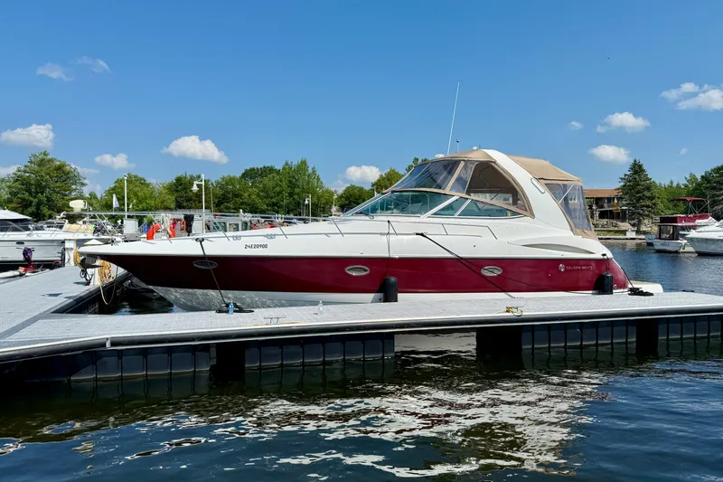  Yacht Photos Pics 2004 Cruisers Yachts 3672 docked at marina under clear blue sky.