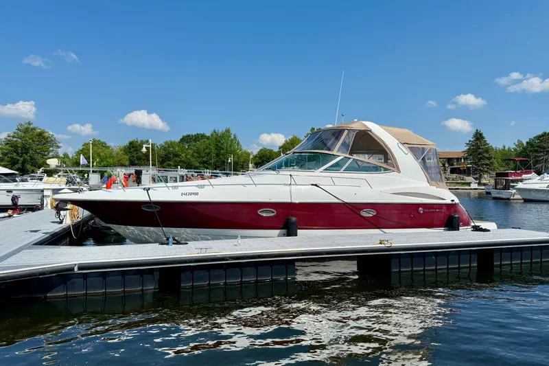  Yacht Photos Pics 2004 Cruisers Yachts 3672 docked at marina under clear blue sky.