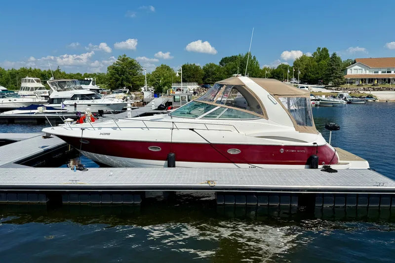  Yacht Photos Pics 2004 Cruisers Yachts 3672 docked at marina under clear blue sky.