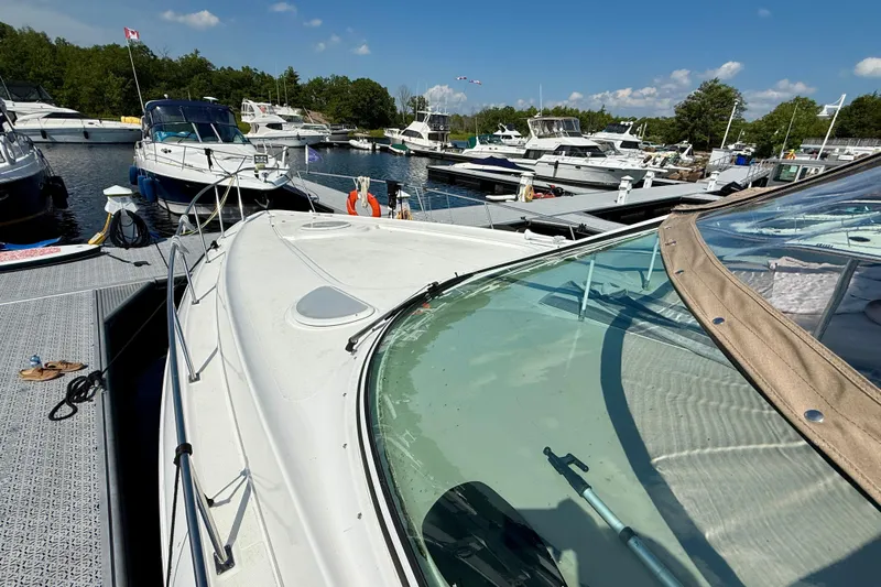  Yacht Photos Pics 2004 Cruisers Yachts 3672 docked at marina with other boats under clear blue sky.