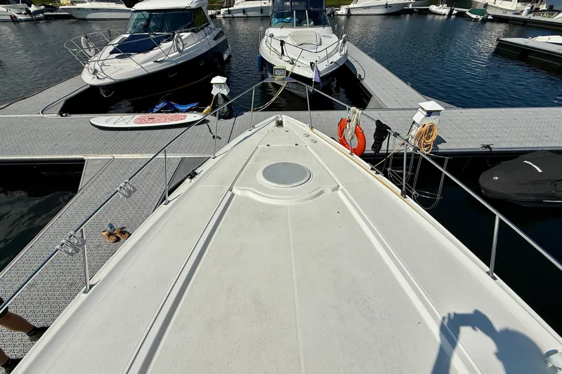  Yacht Photos Pics 2004 Cruisers Yachts 3672 docked at marina, surrounded by other boats.