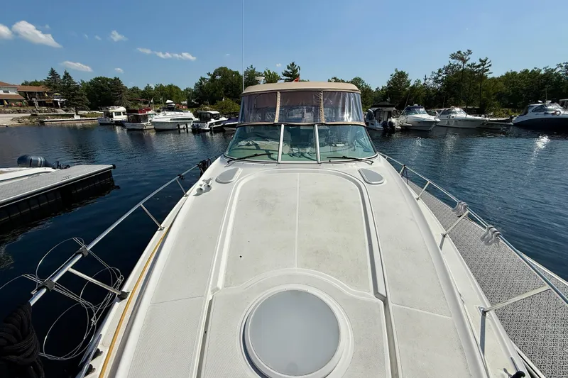  Yacht Photos Pics 2004 Cruisers Yachts 3672 docked in a scenic marina under a clear blue sky.