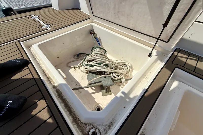  Yacht Photos Pics Open storage compartment on 2004 Cruisers Yachts 3672 with rope and anchor inside.