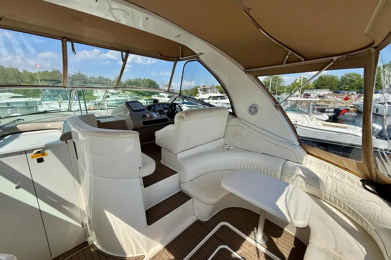  Yacht Photos Pics 2004 Cruisers Yachts 3672 interior with helm, seating, and marina view.