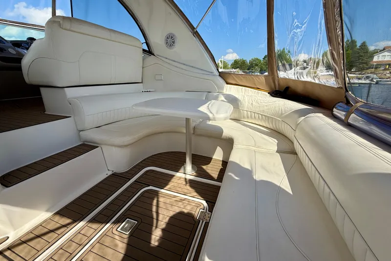  Yacht Photos Pics Luxurious 2004 Cruisers Yachts 3672 interior with white seating and wooden flooring.