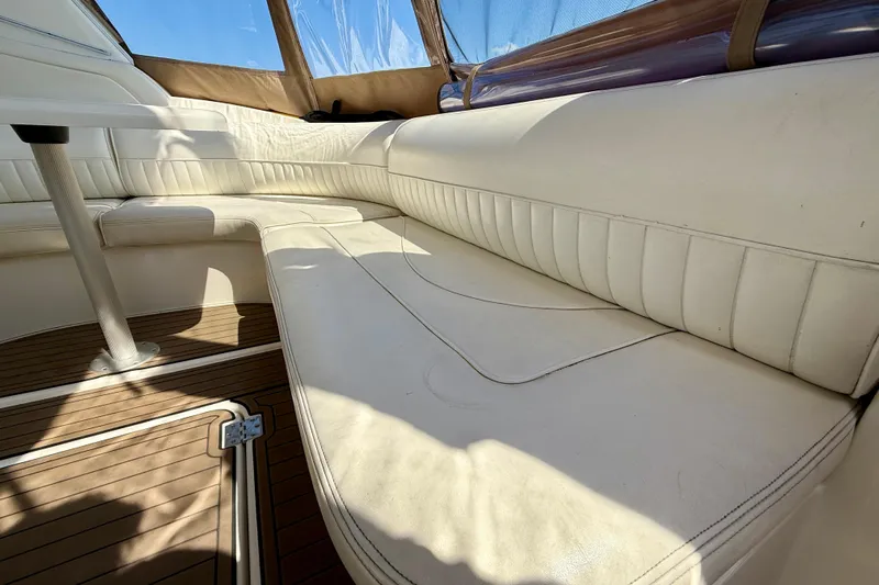  Yacht Photos Pics 2004 Cruisers Yachts 3672 interior with white leather seating and wooden flooring.