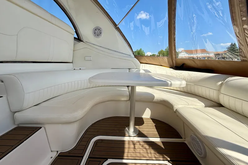  Yacht Photos Pics Luxurious interior of 2004 Cruisers Yachts 3672 with white seating and wooden flooring.
