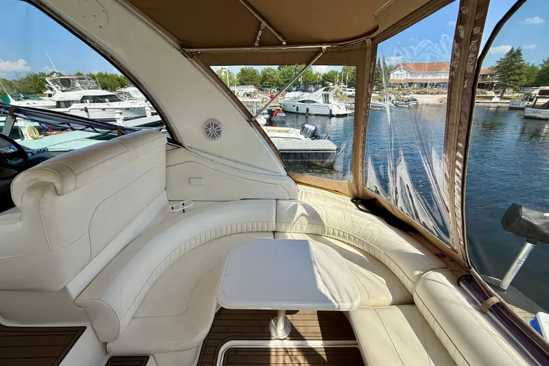  Yacht Photos Pics Luxurious 2004 Cruisers Yachts 3672 interior with white seating and marina view.