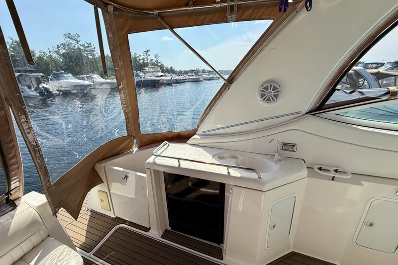  Yacht Photos Pics 2004 Cruisers Yachts 3672 interior with sink, overlooking marina and boats.