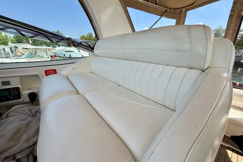  Yacht Photos Pics 2004 Cruisers Yachts 3672 interior with white leather seating and marina view.