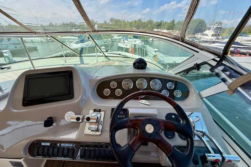  Yacht Photos Pics 2004 Cruisers Yachts 3672 helm with steering wheel, controls, and navigation display.