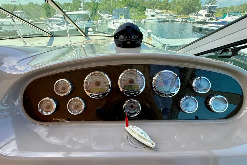  Yacht Photos Pics Dashboard of a 2004 Cruisers Yachts 3672 with gauges and compass, docked at marina.