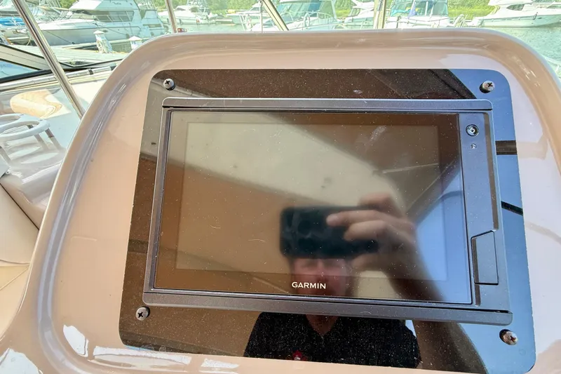  Yacht Photos Pics Garmin navigation system on 2004 Cruisers Yachts 3672 dashboard, marina background.