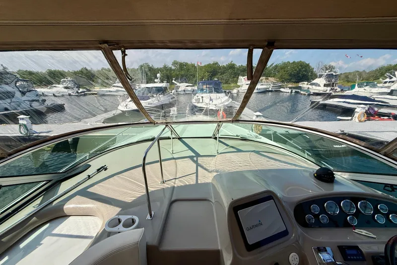  Yacht Photos Pics 2004 Cruisers Yachts 3672 helm view, marina backdrop, clear skies, Garmin navigation system.