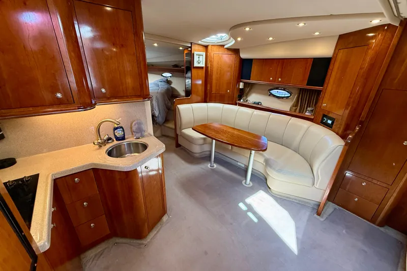  Yacht Photos Pics Luxurious 2004 Cruisers Yachts 3672 interior with elegant wood cabinetry and cozy seating area.