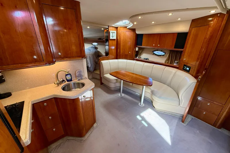  Yacht Photos Pics Luxurious 2004 Cruisers Yachts 3672 interior with wood cabinetry and plush seating.