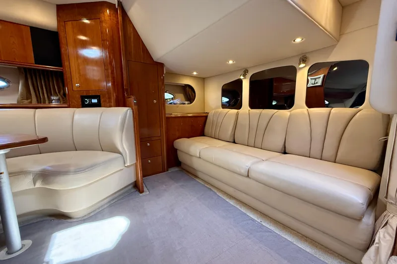  Yacht Photos Pics Luxurious interior of 2004 Cruisers Yachts 3672 with plush seating and elegant wood finishes.