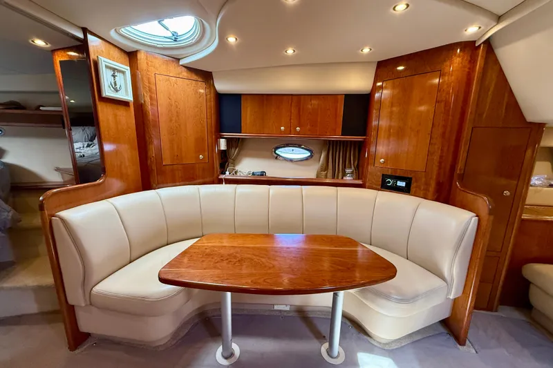  Yacht Photos Pics 2004 Cruisers Yachts 3672 interior with elegant wood finish and cozy seating area.