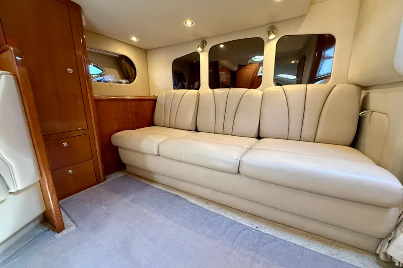  Yacht Photos Pics Luxurious interior of 2004 Cruisers Yachts 3672 with beige leather seating and wooden cabinetry.