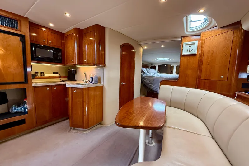 Yacht Photos Pics Luxurious 2004 Cruisers Yachts 3672 interior with kitchen, dining area, and cozy sleeping quarters.