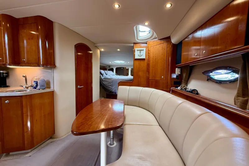  Yacht Photos Pics Luxurious 2004 Cruisers Yachts 3672 interior with elegant wood finishes and cozy seating area.