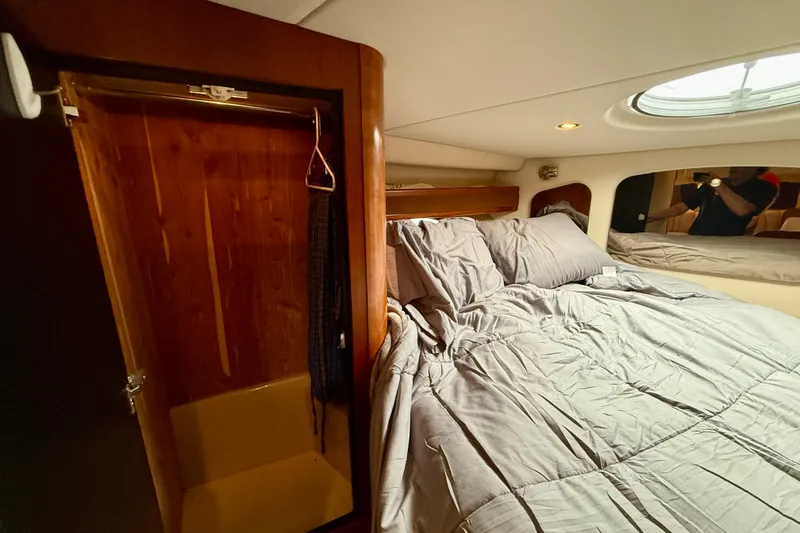  Yacht Photos Pics Cozy bedroom in 2004 Cruisers Yachts 3672 with wooden closet and skylight.