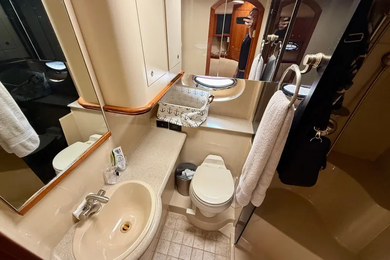  Yacht Photos Pics 2004 Cruisers Yachts 3672 bathroom with sink, toilet, and mirror.