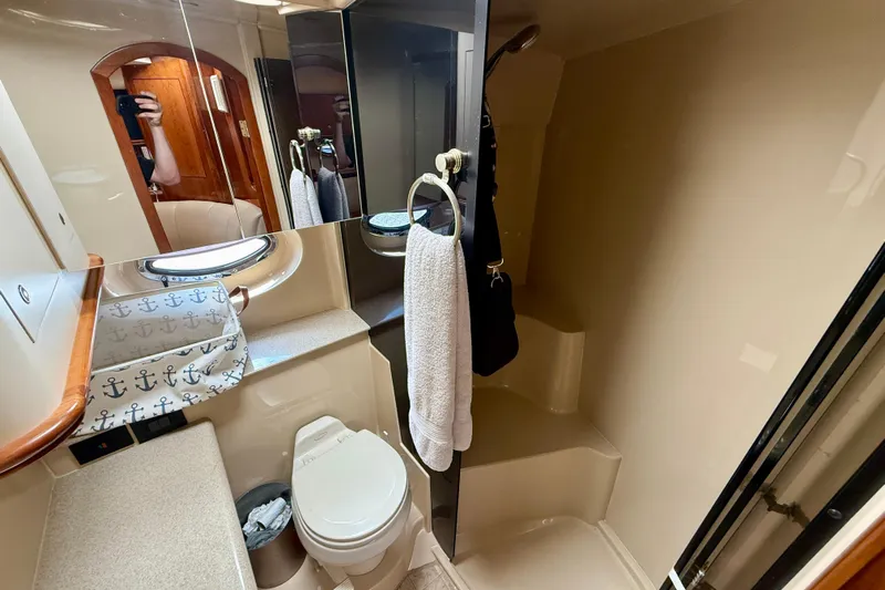  Yacht Photos Pics Bathroom interior of 2004 Cruisers Yachts 3672 with toilet, mirror, and towel.