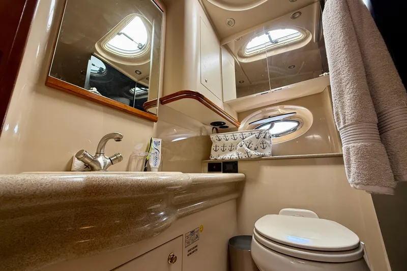  Yacht Photos Pics Luxurious 2004 Cruisers Yachts 3672 bathroom with elegant fixtures and nautical decor.