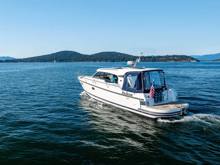Keokuk Yacht Photos Pics Nimbus 365 Coupe 2020 cruising on a scenic lake with distant hills.