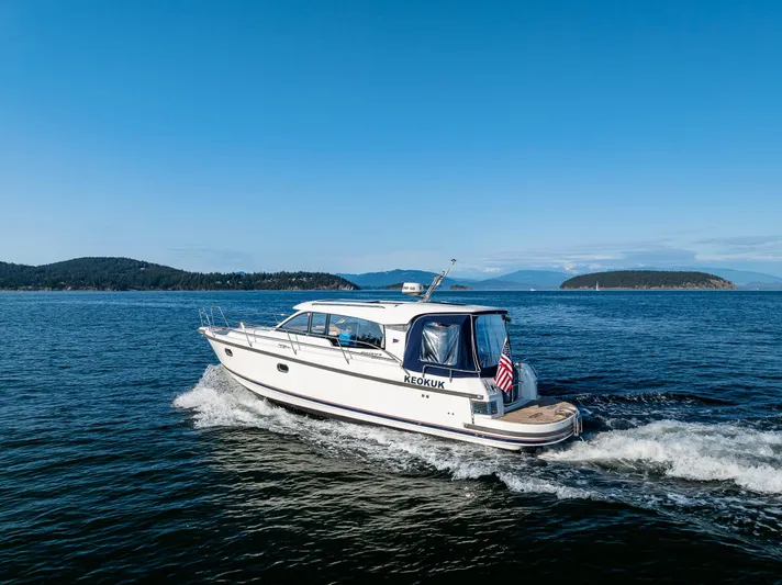 Keokuk Yacht Photos Pics Nimbus 365 Coupe 2020 cruising on open water under clear blue skies.
