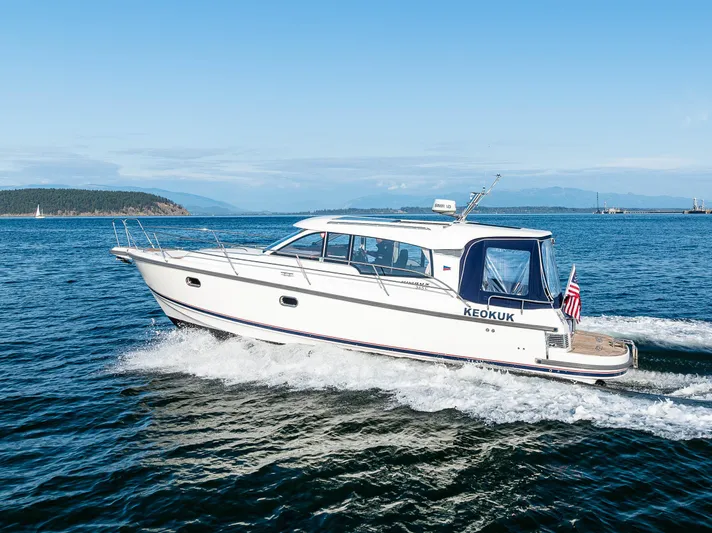 Keokuk Yacht Photos Pics Nimbus 365 Coupe 2020 cruising on open water under clear blue skies.