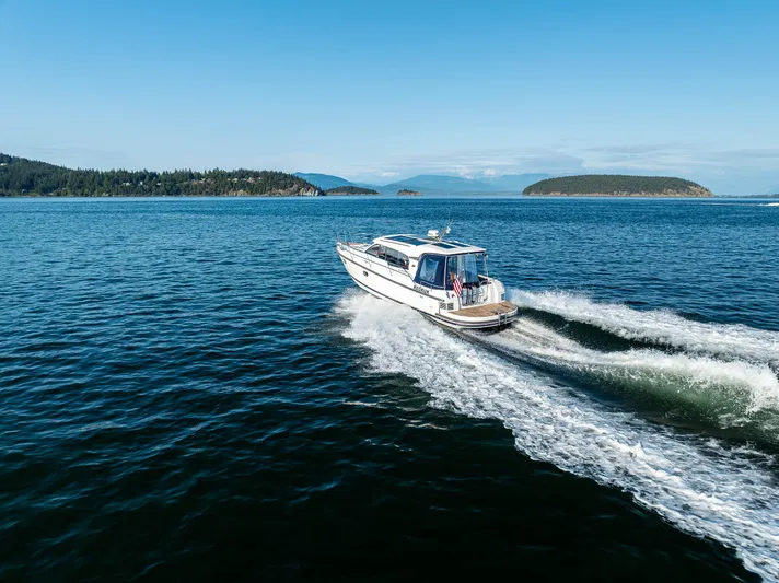 Keokuk Yacht Photos Pics Nimbus 365 Coupe 2020 cruising on open water with scenic island backdrop.