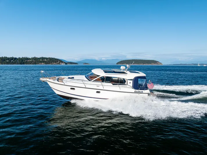 Keokuk Yacht Photos Pics Nimbus 365 Coupe 2020 cruising on open water under clear blue skies.
