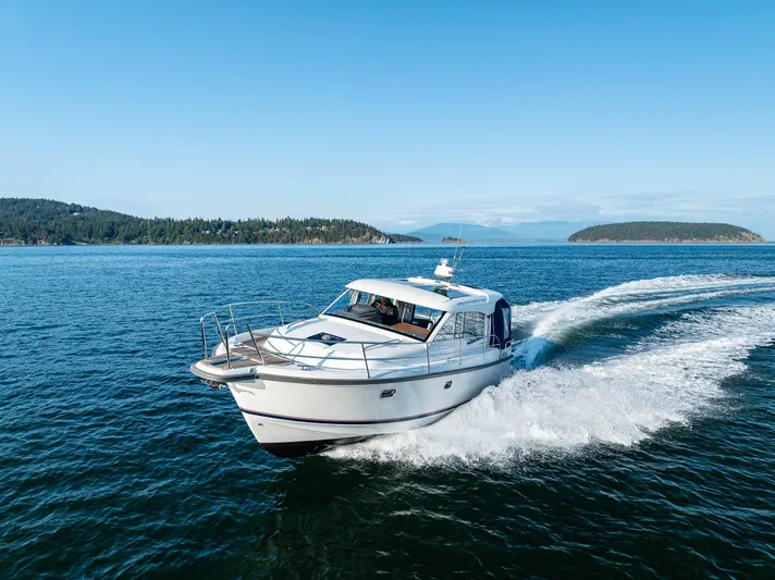 Keokuk Yacht Photos Pics Nimbus 365 Coupe 2020 cruising on open water with scenic island backdrop.