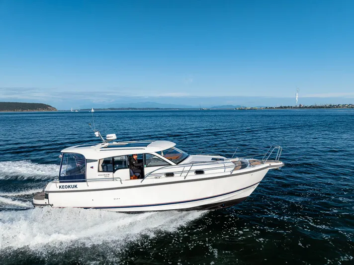 Keokuk Yacht Photos Pics Nimbus 365 Coupe 2020 cruising on open water under clear blue skies.