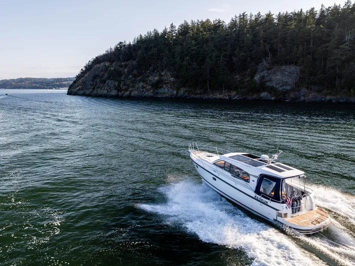 Keokuk Yacht Photos Pics Nimbus 365 Coupe 2020 cruising near a forested coastline.