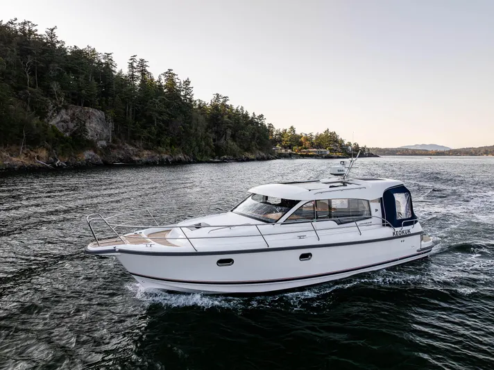 Keokuk Yacht Photos Pics Nimbus 365 Coupe 2020 cruising on scenic waterway near forested shoreline.
