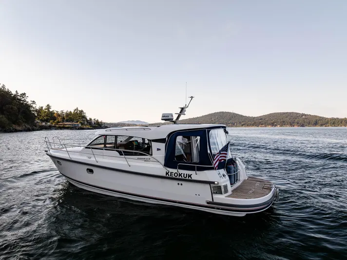 Keokuk Yacht Photos Pics Nimbus 365 Coupe 2020 boat cruising on scenic lake with distant hills.