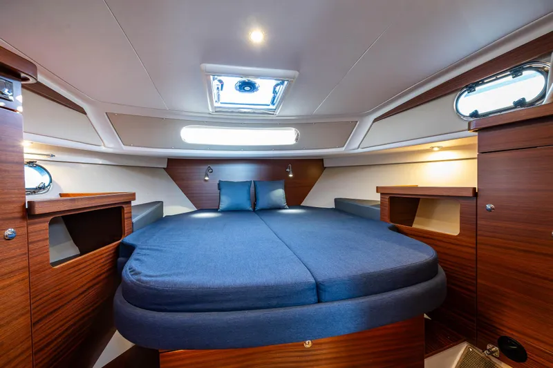Keokuk Yacht Photos Pics Luxurious cabin interior of 2020 Nimbus 365 Coupe with cozy bedding and wooden accents.