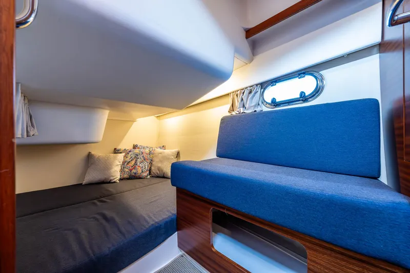Keokuk Yacht Photos Pics Cozy interior cabin of 2020 Nimbus 365 Coupe with blue seating and bedding.