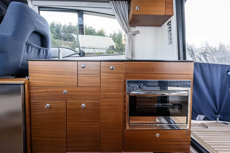 Keokuk Yacht Photos Pics Interior of 2020 Nimbus 365 Coupe with wooden cabinetry and modern appliances.