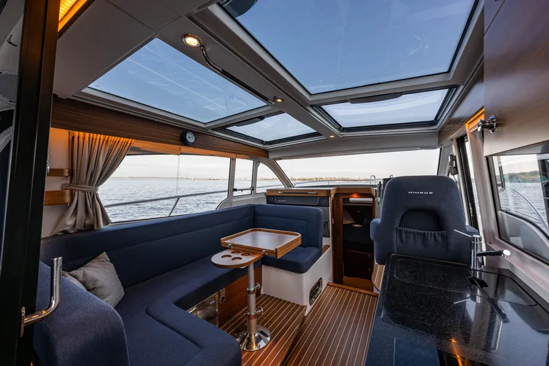 Keokuk Yacht Photos Pics Luxurious interior of 2020 Nimbus 365 Coupe boat with panoramic windows and elegant seating.
