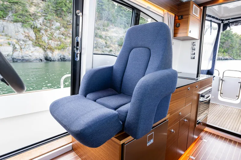 Keokuk Yacht Photos Pics Luxurious interior of 2020 Nimbus 365 Coupe with plush blue captain's chair.