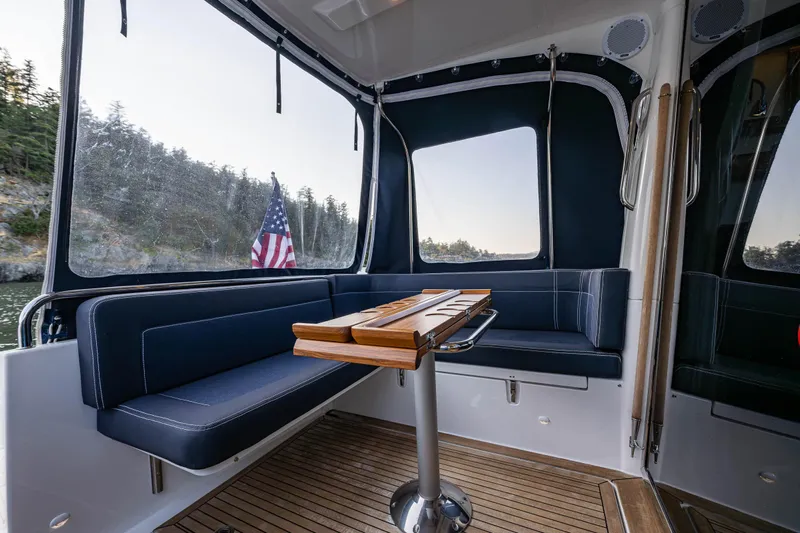 Keokuk Yacht Photos Pics Interior of 2020 Nimbus 365 Coupe with seating and table, featuring an American flag.