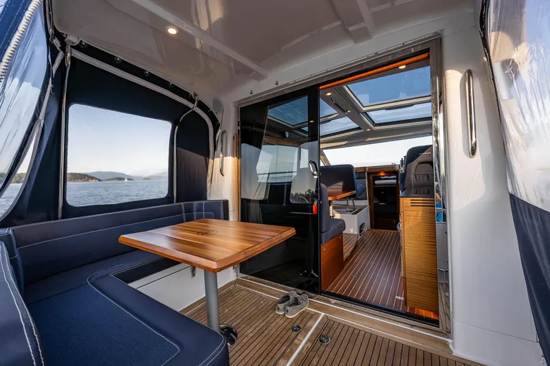 Keokuk Yacht Photos Pics Interior of 2020 Nimbus 365 Coupe yacht with seating and wooden table.
