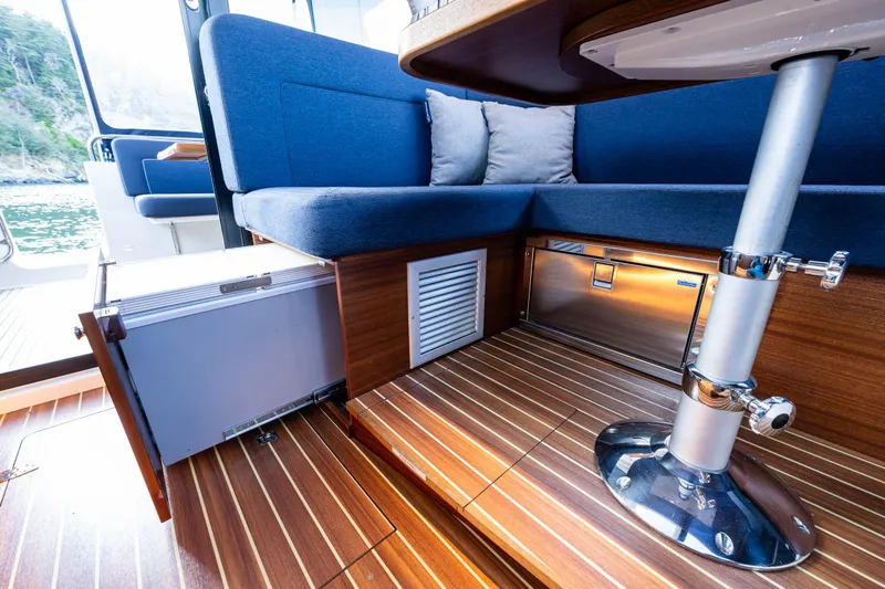 Keokuk Yacht Photos Pics Interior of 2020 Nimbus 365 Coupe with blue seating and wooden flooring.