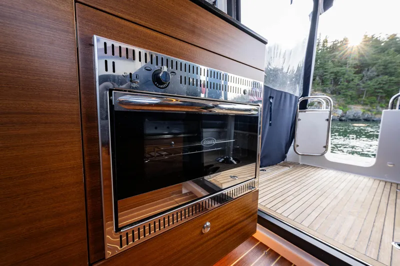 Keokuk Yacht Photos Pics Nimbus 365 Coupe 2020 interior with sleek oven and scenic outdoor view.