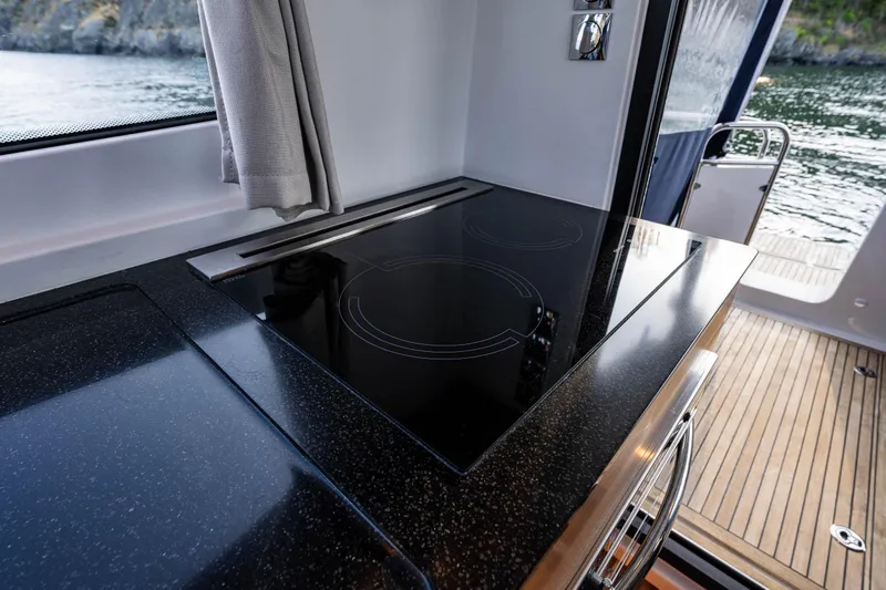 Keokuk Yacht Photos Pics Modern kitchen area in 2020 Nimbus 365 Coupe yacht with sleek black countertop.